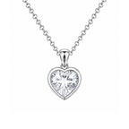 Heart-shaped silver pendant with clear gemstone on a white background